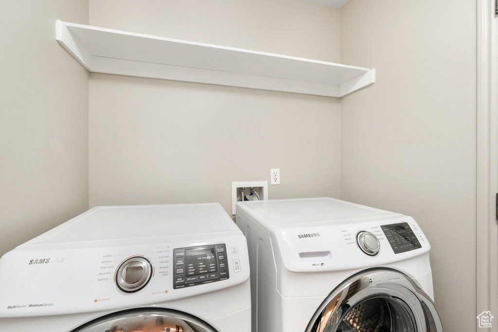 Clothes washing area featuring washer and dryer and washer hookup