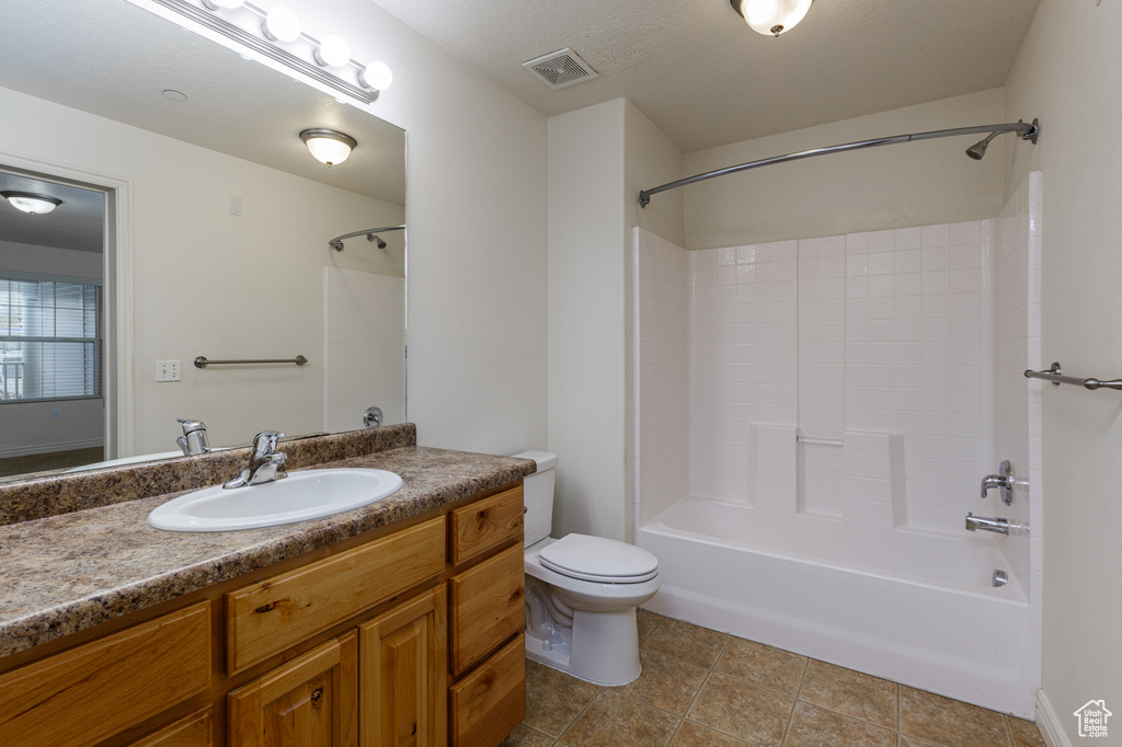 Full bathroom with shower / washtub combination, tile floors, vanity, and toilet