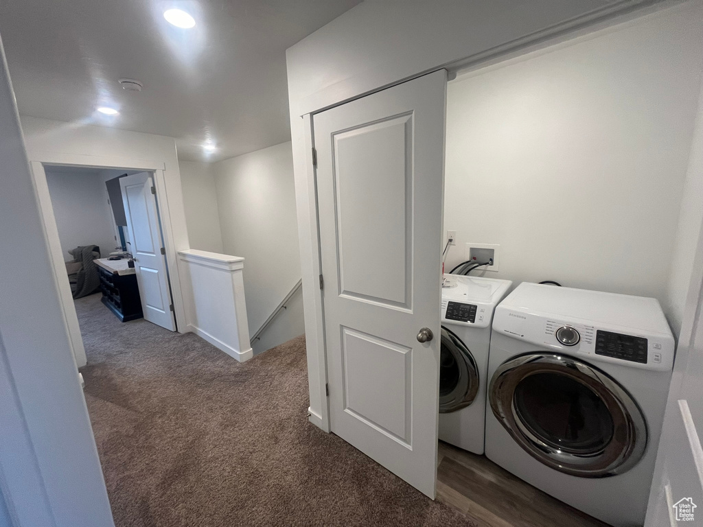 Laundry area with hookup for a washing machine, washing machine and clothes dryer, and dark carpet