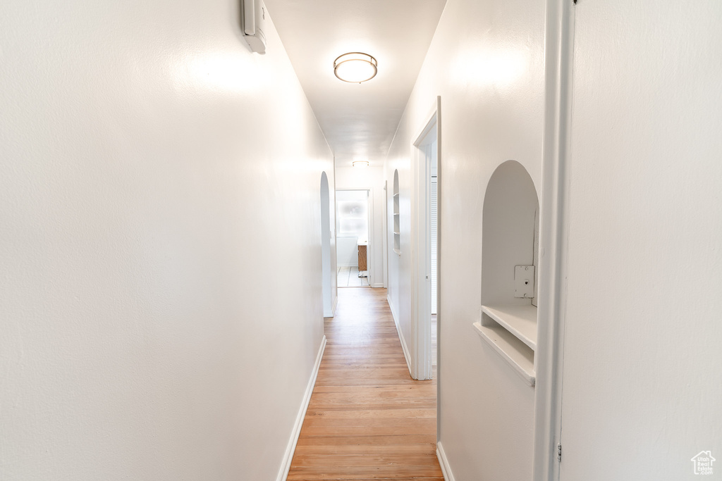 Hallway with light hardwood / wood-style floors
