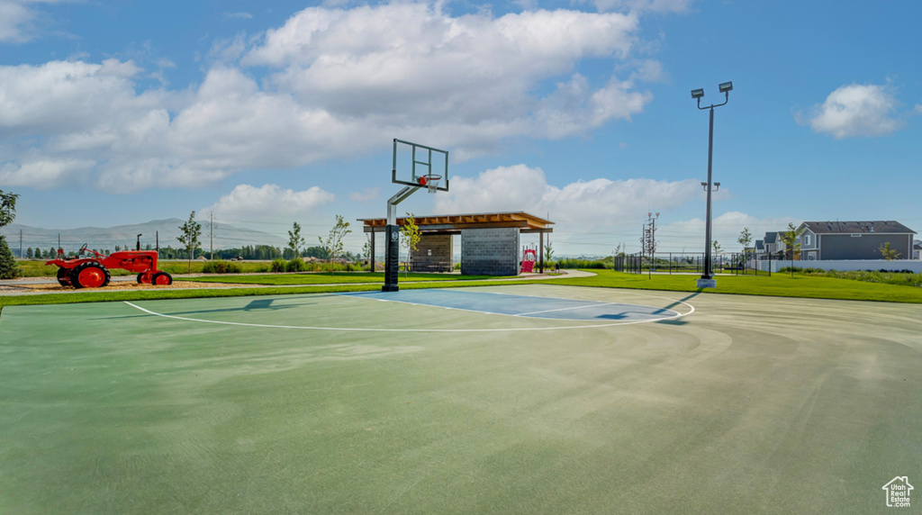 View of basketball court with a lawn