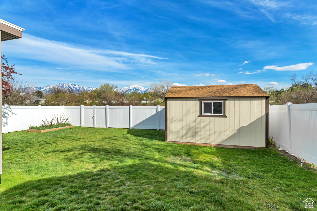 View of yard featuring a mountain view and a storage shed