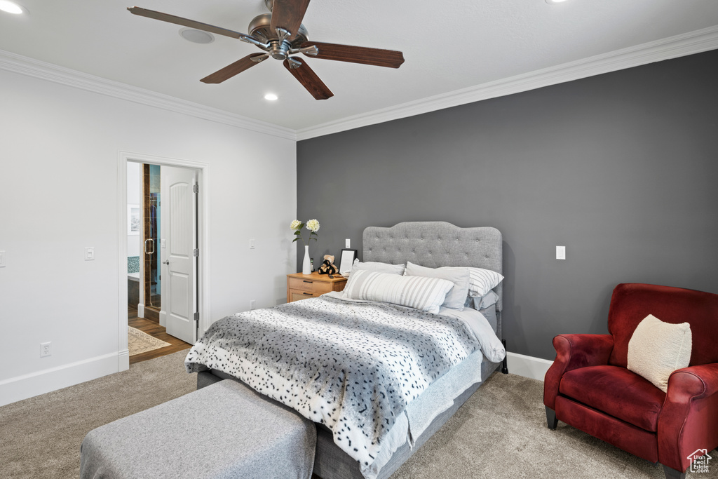 Carpeted bedroom with ornamental molding and ceiling fan
