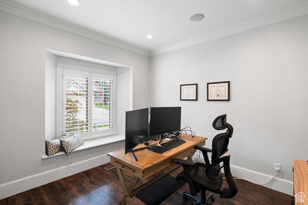 Office area with crown molding and dark wood-type flooring