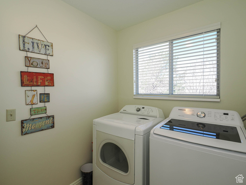 Laundry room featuring a wealth of natural light and washer and clothes dryer