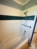Bathroom with tiled shower / bath and tile flooring