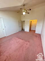 Unfurnished bedroom with carpet, ceiling fan, and lofted ceiling
