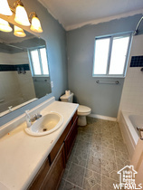 Full bathroom featuring tile flooring, a chandelier, toilet,  shower combination, and vanity