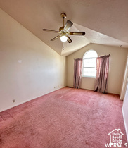 Spare room with light carpet, lofted ceiling, and ceiling fan