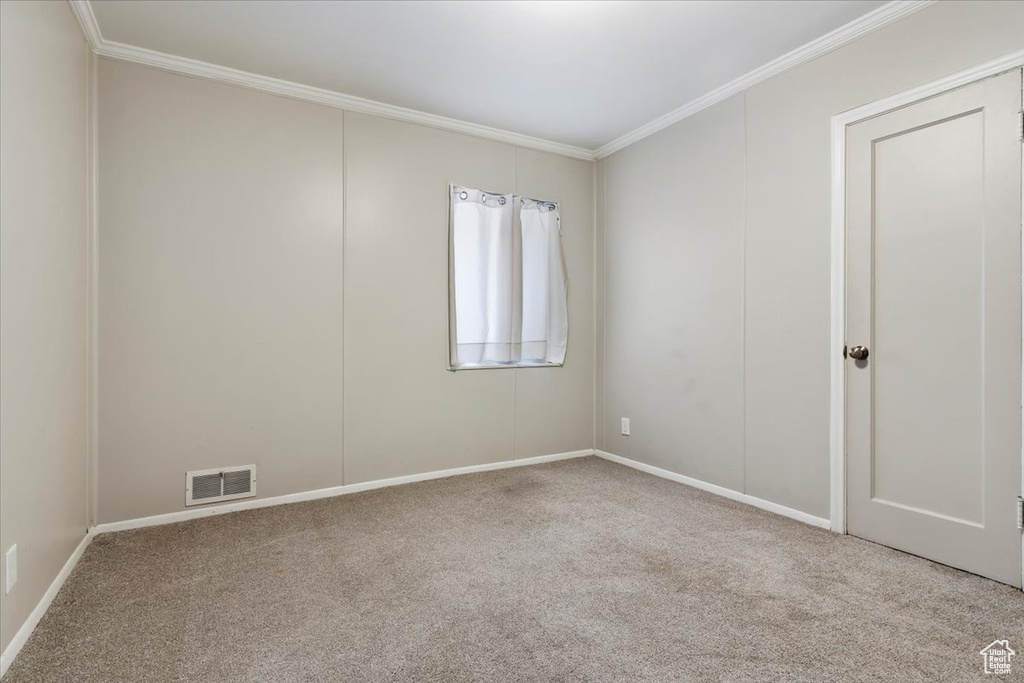 Unfurnished room featuring light carpet and ornamental molding