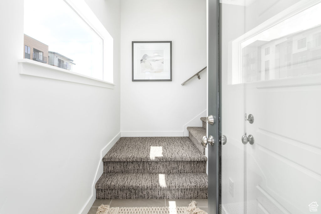 Stairway featuring tile flooring
