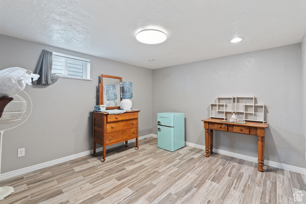 Miscellaneous room with light hardwood / wood-style floors and a textured ceiling