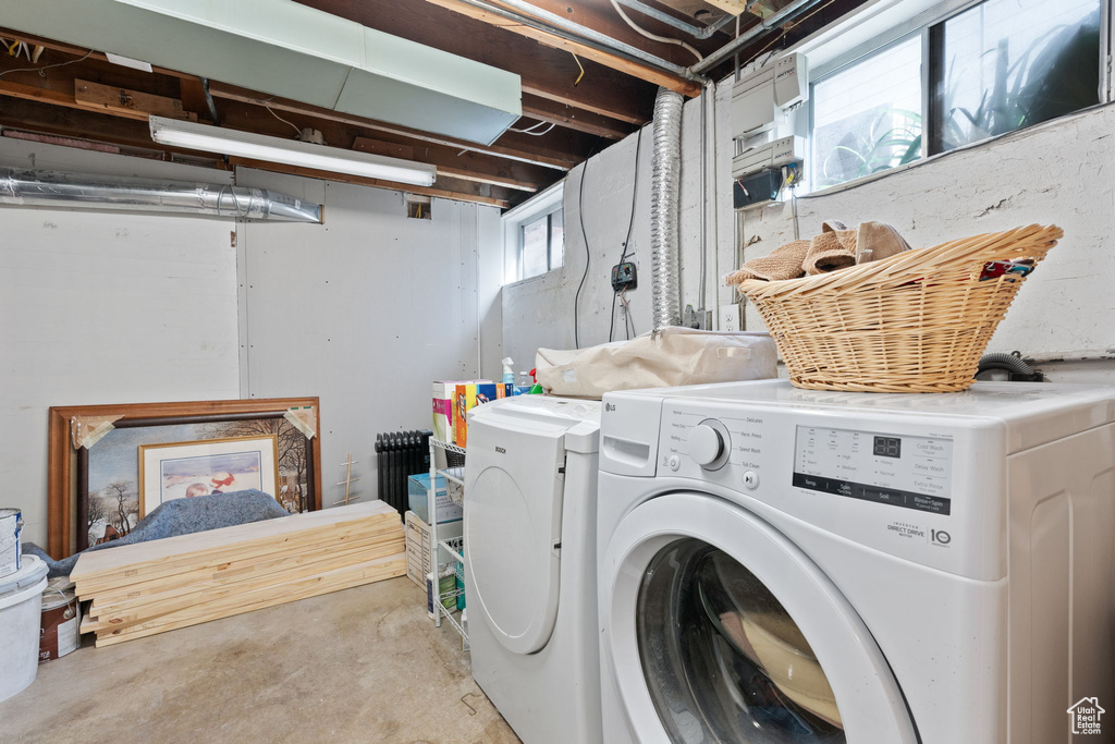Laundry area featuring a healthy amount of sunlight and independent washer and dryer