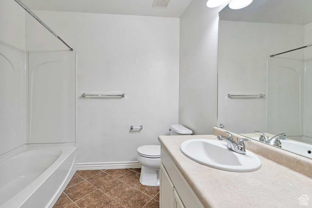 Full bathroom with shower / bath combination, oversized vanity, tile floors, and toilet