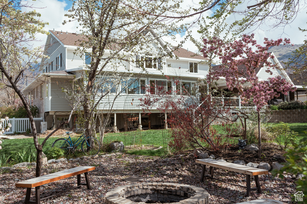 Rear view of property featuring a fire pit