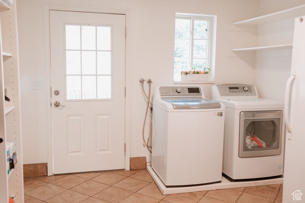 Laundry room featuring light tile flooring and washer and dryer