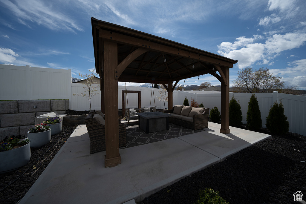 View of patio featuring outdoor lounge area and a gazebo