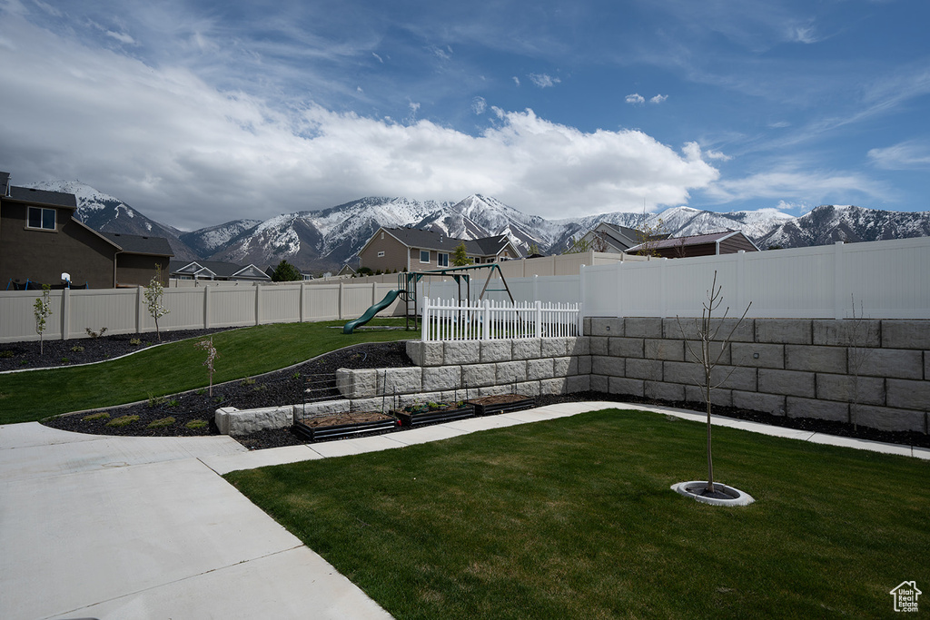 View of yard with a mountain view and a playground