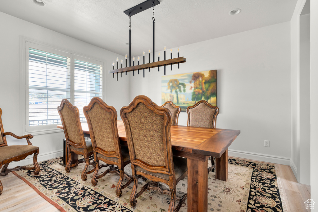 Dining room featuring light hardwood / wood-style floors and a chandelier