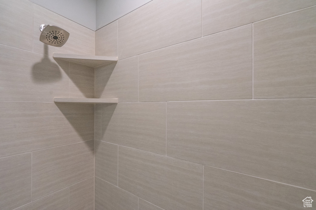 Room details featuring tiled shower