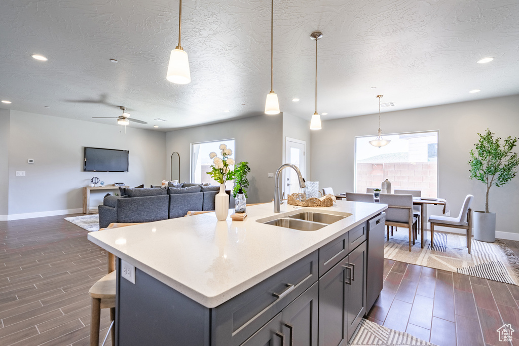 Kitchen featuring a healthy amount of sunlight, decorative light fixtures, and sink