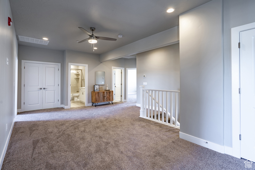 Unfurnished living room with light colored carpet and ceiling fan