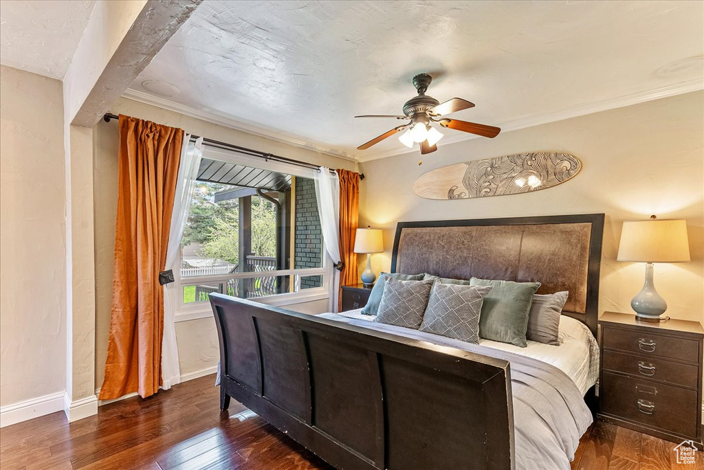 Bedroom featuring crown molding, dark wood-type flooring, and ceiling fan
