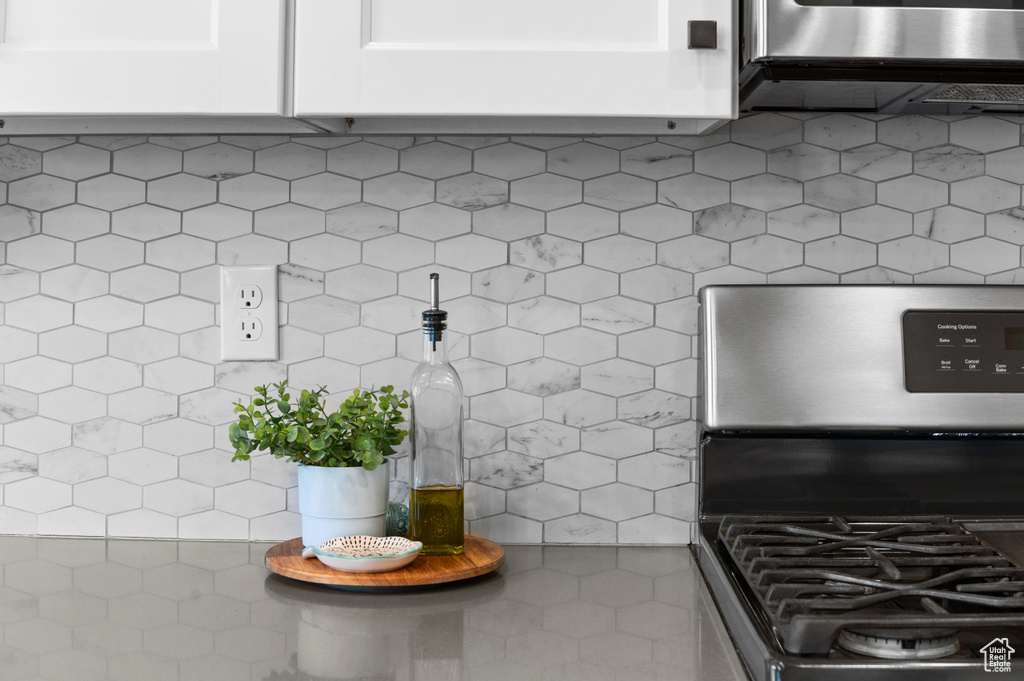 Details with stainless steel gas stove and tasteful backsplash