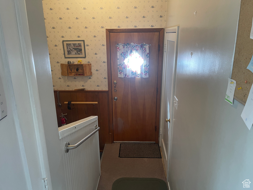 Doorway to outside featuring carpet