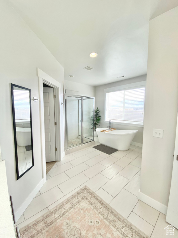 Bathroom with plus walk in shower and tile floors