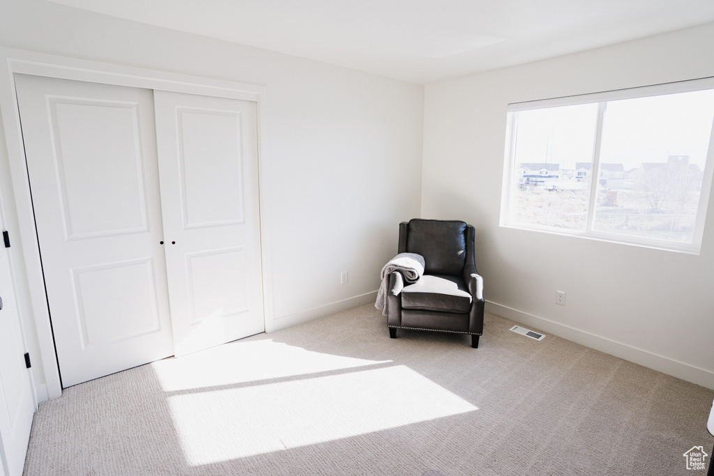 Unfurnished room featuring light carpet