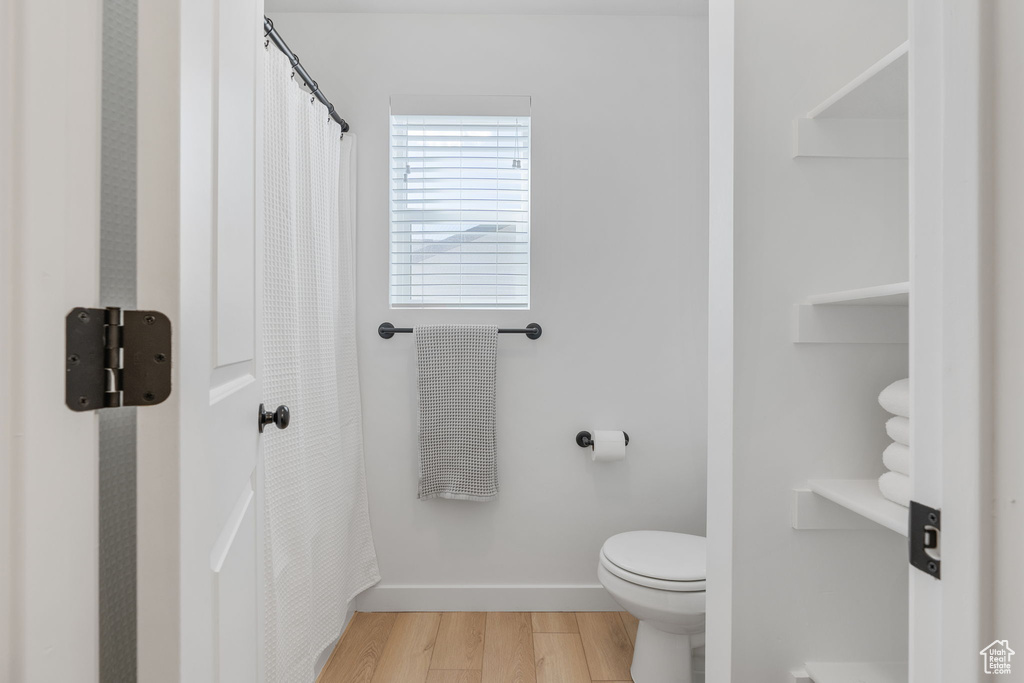 Bathroom featuring toilet and hardwood / wood-style floors