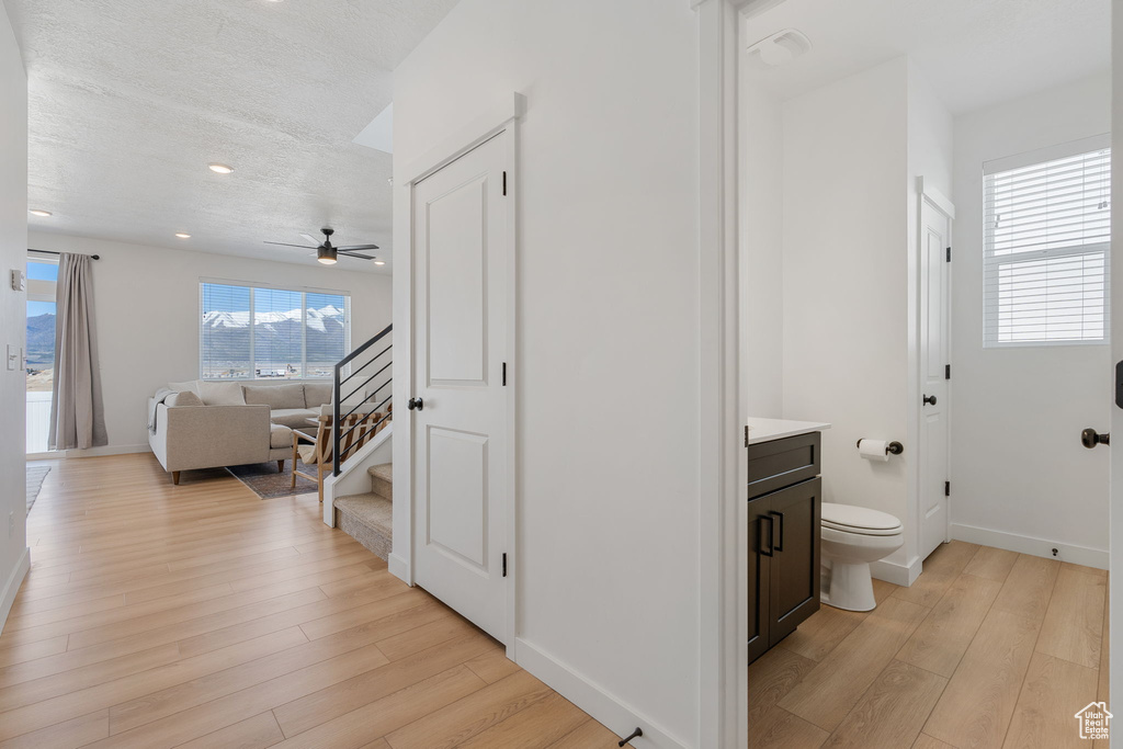 Bathroom featuring hardwood / wood-style floors, vanity, and toilet
