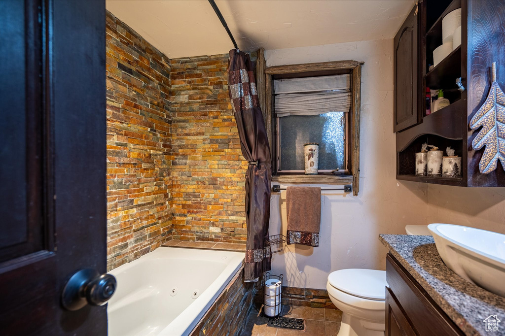 Full bathroom featuring vanity, toilet, tile floors, and shower / bath combination with curtain