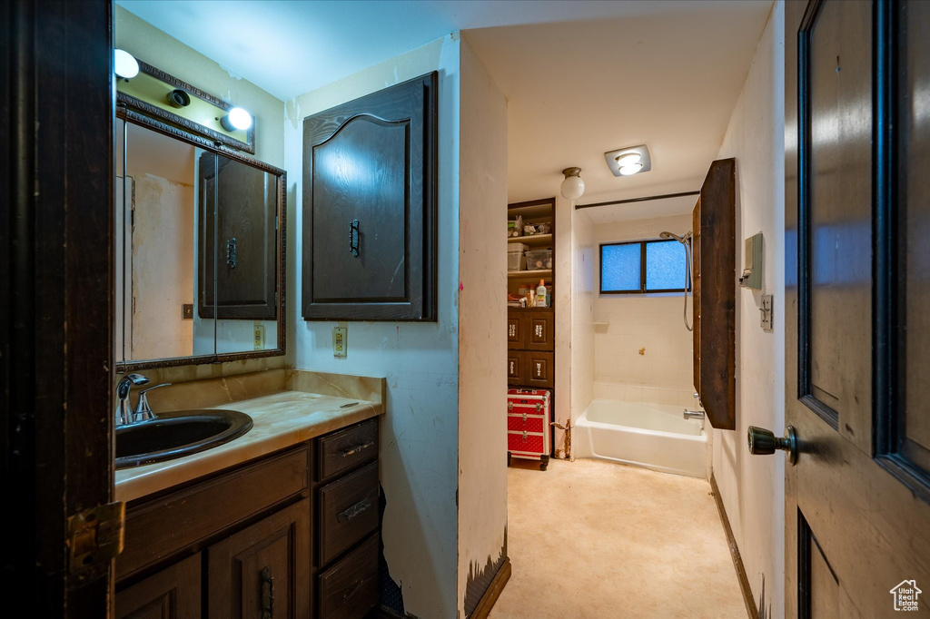 Bathroom featuring vanity and washtub / shower combination