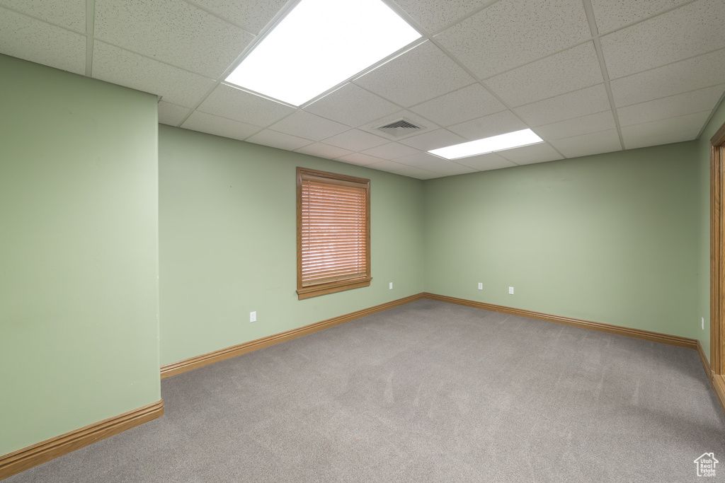 Carpeted spare room with a paneled ceiling