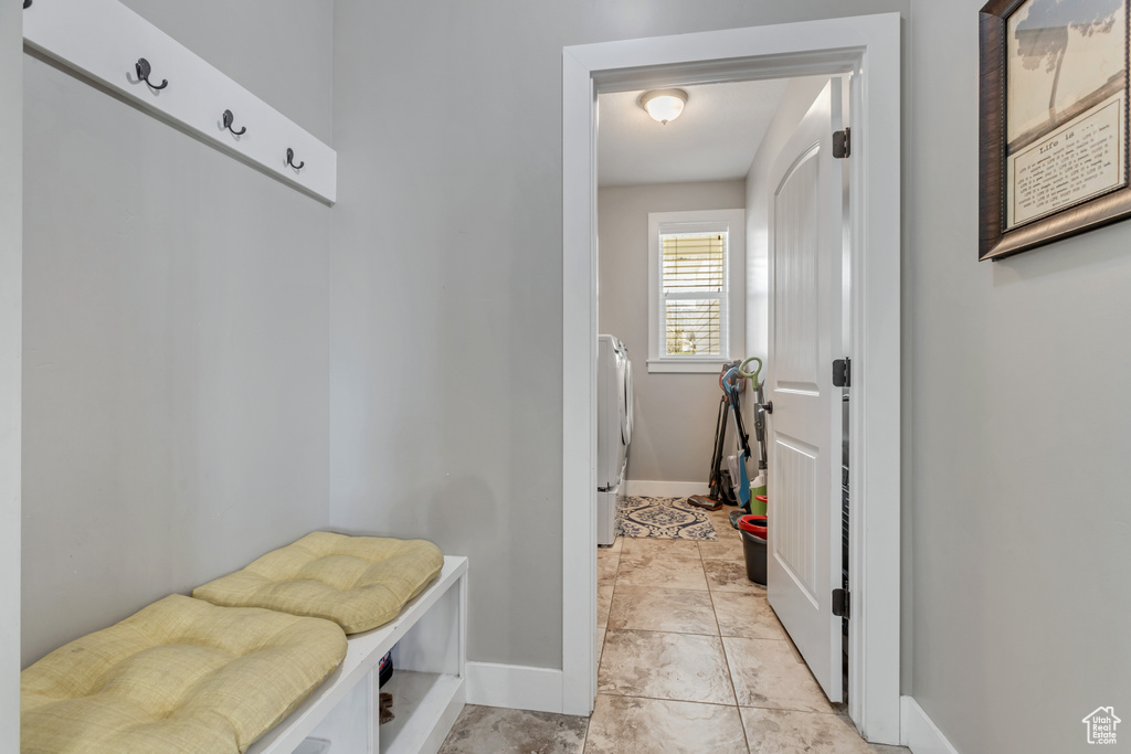 Mudroom featuring light tile floors and washer / dryer