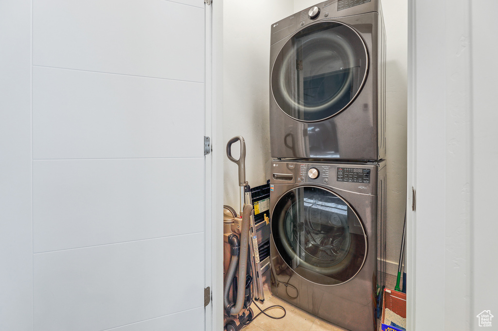 Laundry area with stacked washing maching and dryer