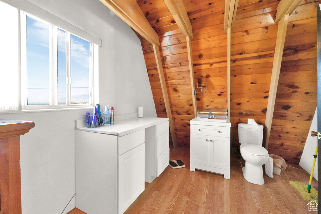 Bathroom with wood ceiling, hardwood / wood-style floors, toilet, and a healthy amount of sunlight