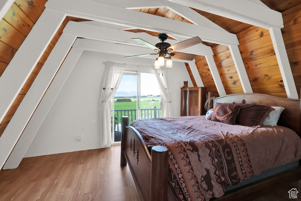 Bedroom with ceiling fan, vaulted ceiling with beams, access to exterior, wood ceiling, and light wood-type flooring