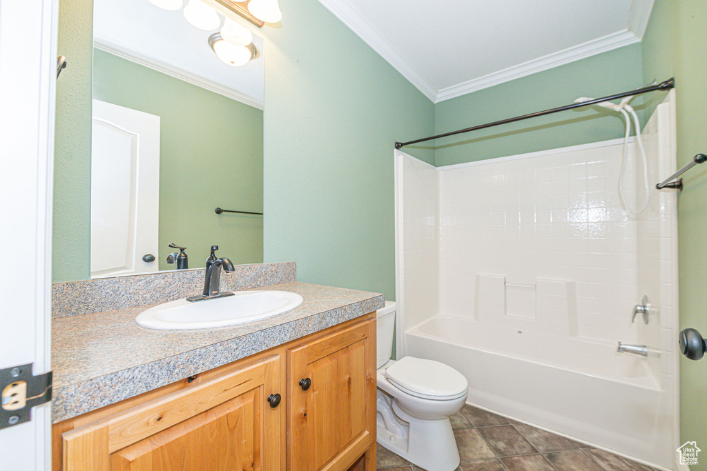 Full bathroom with ornamental molding, vanity, toilet, and shower / washtub combination