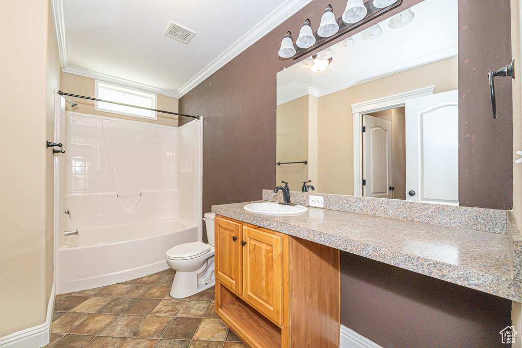 Full bathroom with tile flooring, shower / tub combination, toilet, ornamental molding, and vanity