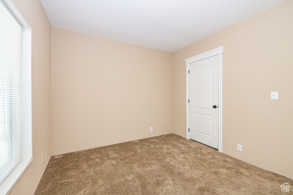 Carpeted empty room with plenty of natural light