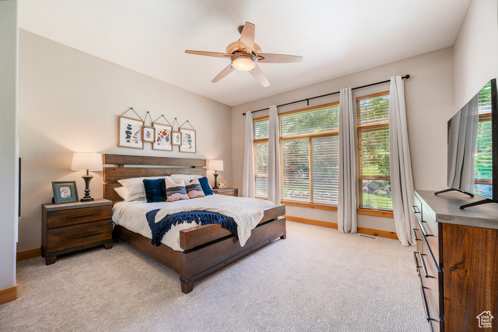 Bedroom with light carpet and ceiling fan