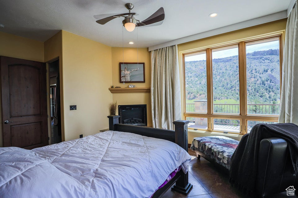 Bedroom featuring ceiling fan and multiple windows