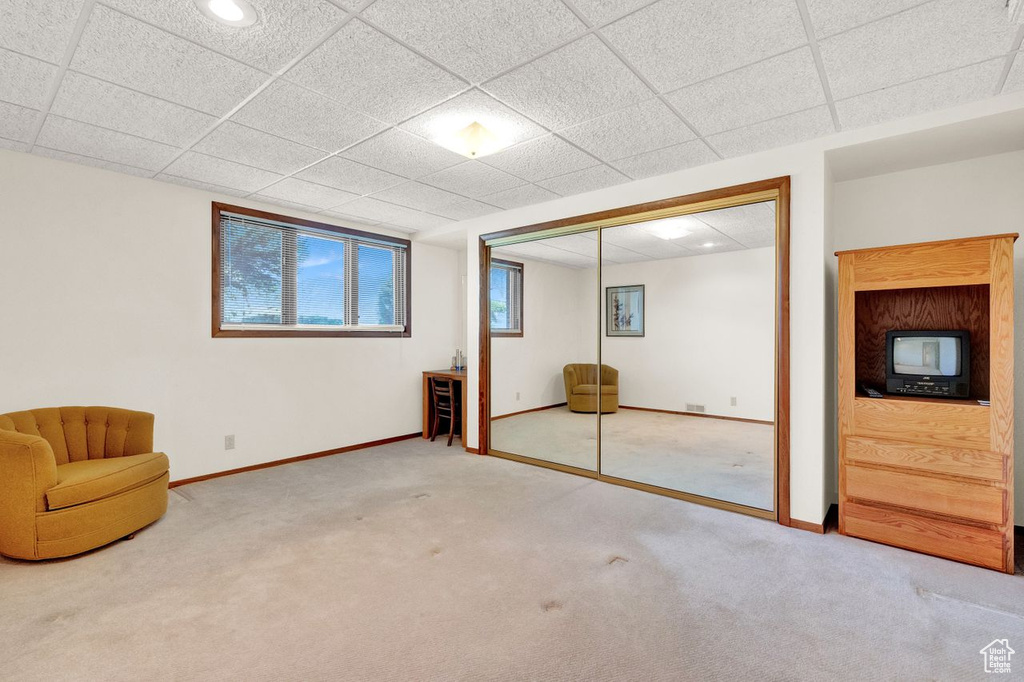 Unfurnished room featuring light colored carpet and a paneled ceiling