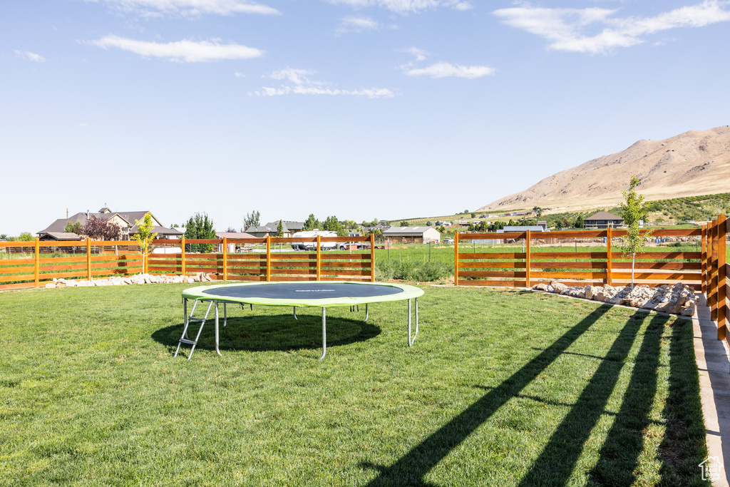 View of yard featuring a mountain view and a trampoline