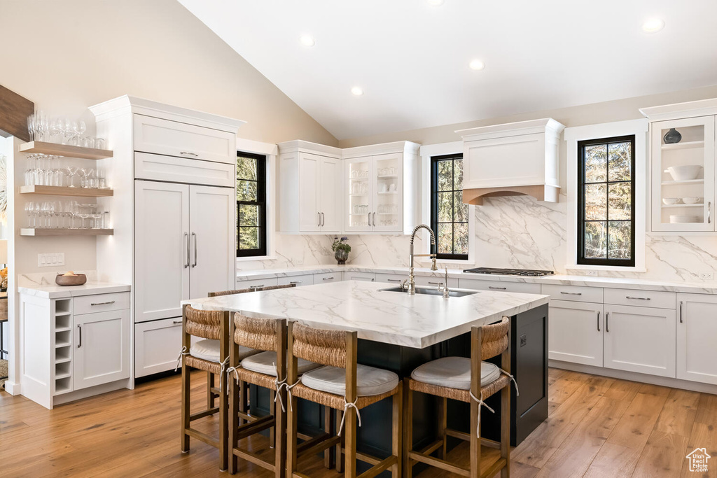 Kitchen featuring white cabinetry and sink