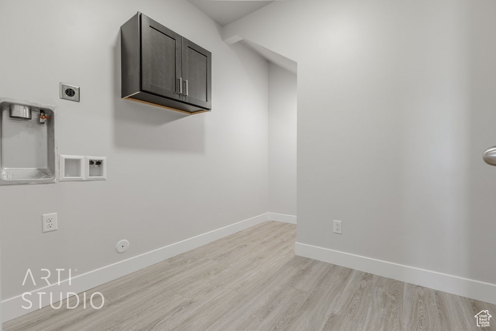 Laundry room with cabinets, washer hookup, gas dryer hookup, light hardwood / wood-style floors, and hookup for an electric dryer