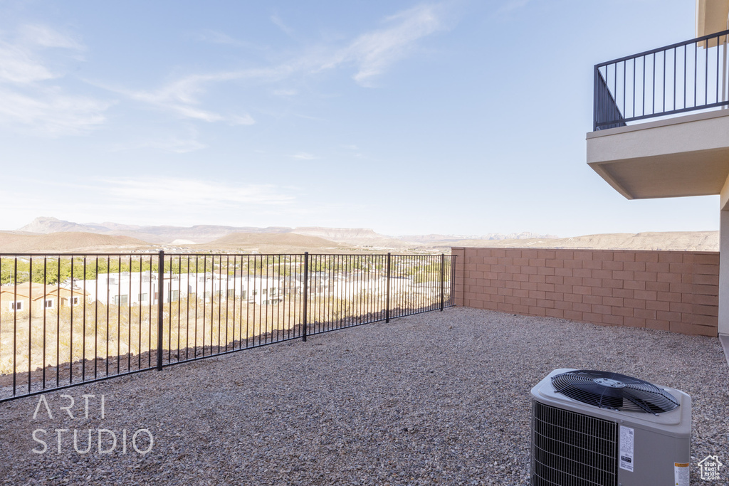 View of patio / terrace with a mountain view, central AC unit, and a balcony